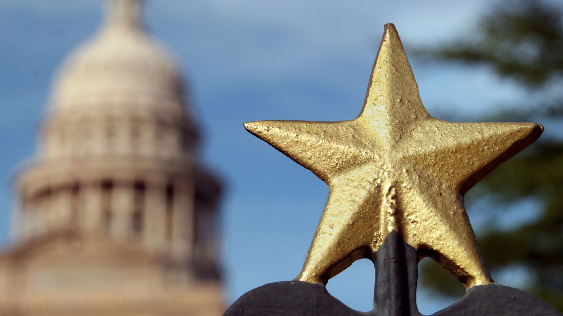 A gilded Lone Star on the Texas Capitol grounds at dusk